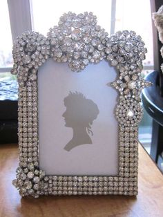 a photo frame with a silhouette of a woman's head in the middle of it