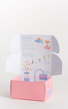 an open pink box with paper cut out of it