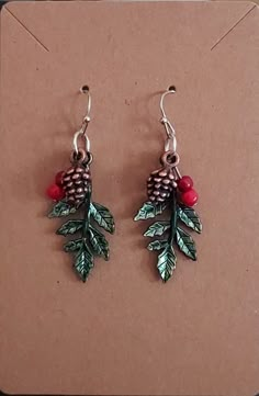 "These are simple drop earrings on ball hooks.  The finish is silver in color with green holly leaves, red \"berry\" beads and small bronze pinecones.   Processing time on these is running 4-5 days due to availability of materials." Xmas Jewelry, Jewelry To Sell, Christmas Beading, Diy Jewelry To Sell, Beading Earrings, Beaded Leaf, Holiday Earrings, Holly Leaves, Holly Berry