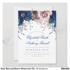 a wedding card with flowers and leaves on the front, in navy blue and white watercolor