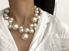 🌟 Elevate your elegance with our Pearl Necklace, showcasing a blend of European and American style! This stunning piece is perfect for the modern woman, adding a touch of sophistication to any outfit, whether you're traveling or attending a wedding. ️ Ideal for girls who love personality-driven fashion, this necklace is a must-have accessory for 2023. Shine bright and make a statement with this timeless piece! ✨ Classic Pearl White Bridal Necklace For Party, Pearl White Round Bridal Necklace For Party, Chic Pearl White Jewelry For Wedding, Glamorous White Bridal Necklace For Anniversary, Elegant Round Bridal Necklace For Parties, Chic White Necklaces For Wedding, Chic White Wedding Necklaces, White Round Bridal Necklace For Evening, Glamorous White Necklaces For Evening