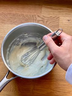 a person is whisking batter in a pan