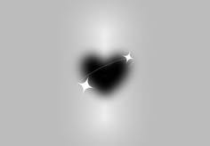 a black heart shaped object with white stars on it's side, in front of a gray background