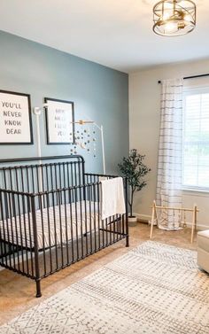 a baby's room with a black crib and white rug