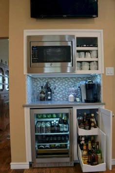 an open refrigerator and microwave in a kitchen