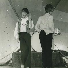 two young men are dancing on stage together