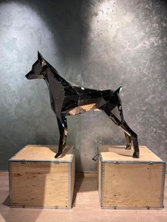 a sculpture of a dog standing on top of two wooden boxes