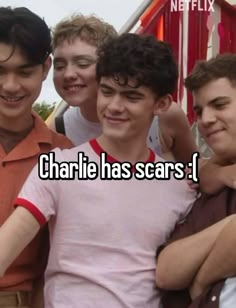 four young men standing next to each other with the caption charlie has scars