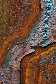 an orange and brown rock with some blue paint on it