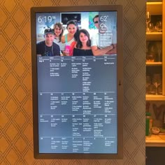 a digital menu board with people on it