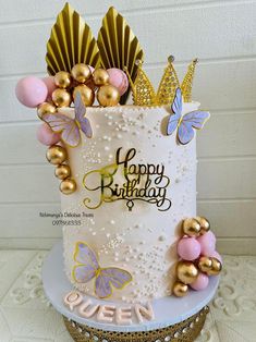 a birthday cake decorated with gold and pink decorations