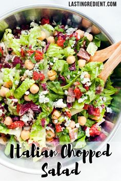 a salad with lettuce, chickpeas and feta cheese in it