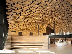 the inside of a building with wooden stairs