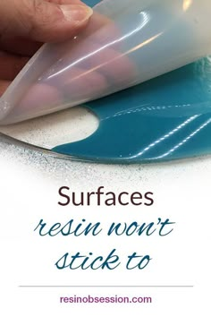 a person is using a blue and white object with text that reads surfaces resin won't stick to