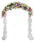 a wedding arch decorated with flowers and ribbons