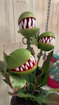 some fake plants with teeth on them in a pot