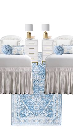 two beds with blue and white bedding on top of a rug next to each other