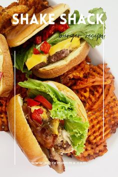 a white plate topped with two sandwiches and french fries