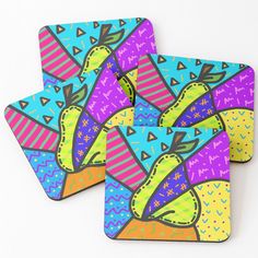 two coasters with colorful designs on them