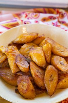 a white bowl filled with sliced bananas on top of a table