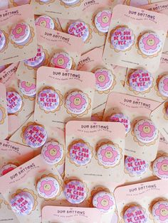 lots of pink and yellow buttons with words on them