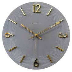 a clock with gold hands and numbers on the face