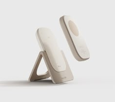 an image of a phone stand with two phones on it's sides and one in the air