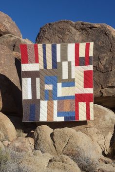 a patchwork quilt on rocks in the desert