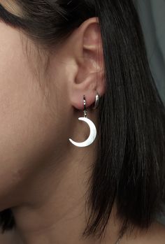 Selena. Shine with the light of the Moon. This unique pair of earrings is composed of rhodium filled huggies and sterling silver crescent moons. Perfect pair to give a witchy vibe to any outfit. Makes a very cute gift! Earring length: 1.2 inches / 3 cm ✺They are sold as a pair✺ ❈ We send all our items with registered mail. ❉ Due to the organic nature of stones, there might be a slight variation in colour, size and shape. ✺ All items come packaged in a quality velvet pouch ready for gift giving. ✽ If you want to make a special order, just contact us! Moon Dangle Earrings, Minimalist Silver Moon Phase Earrings, Minimalist Moon-shaped Sterling Silver Cartilage Earrings, Moon Shaped Sterling Silver Earrings For Everyday, Sterling Silver Moon Earrings For Everyday, Sterling Silver Moon Shaped Earrings For Everyday, Minimalist Sterling Silver Hoop Earrings With Moon Charm, Sterling Silver Moon Charm Earrings For Everyday, Minimalist Silver Moon Earrings