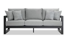 a gray couch with four pillows on it