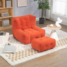 an orange chair and ottoman in a living room