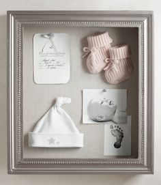 a baby's birth shadow box with pictures and items