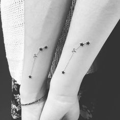 two small stars on the wrist and one with a chain around it, both in black and white