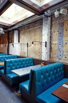 the interior of a restaurant with blue booths