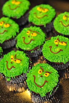 cupcakes decorated with green frosting and smiling faces