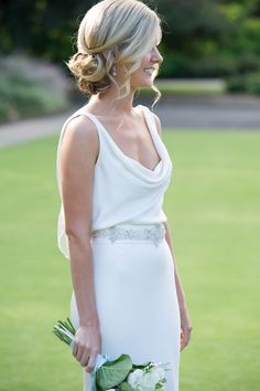 a woman in a white dress holding a bouquet