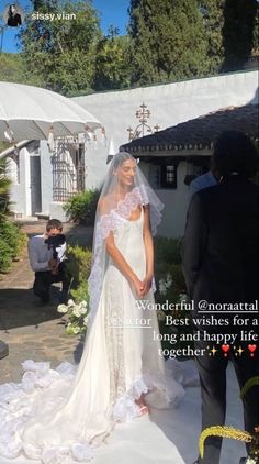 a woman in a wedding dress standing next to a man