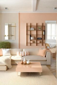 a living room filled with lots of furniture next to a wall mounted bookshelf