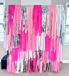 pink and white streamers hanging from the side of a curtain with sequins