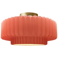 a pink light fixture with a gold rim