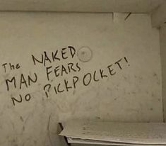 graffiti written on the side of a white wall