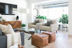 a living room filled with furniture and a flat screen tv mounted on the wall over a fireplace