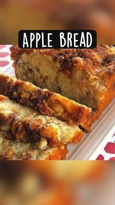 an apple bread sitting on top of a white plate next to a slice of cake