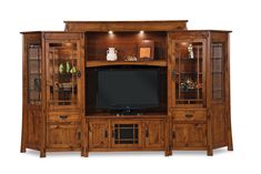 a wooden entertainment center with glass doors and shelves