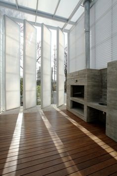 an empty room with wooden floors and white walls