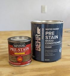 a can of paint next to a tin of wood