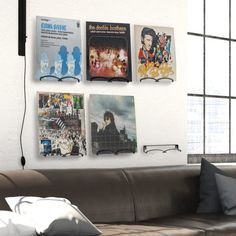 a living room filled with furniture and posters on the wall