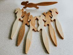 several pieces of wood are arranged on the floor with one being cut out to make a necklace