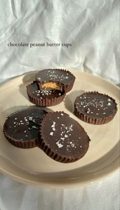 four chocolate peanut butter cups on a plate