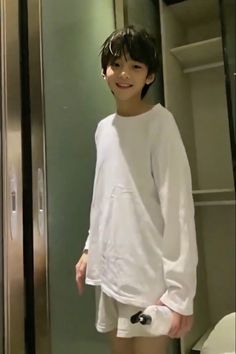 a young man standing in front of a bathroom mirror